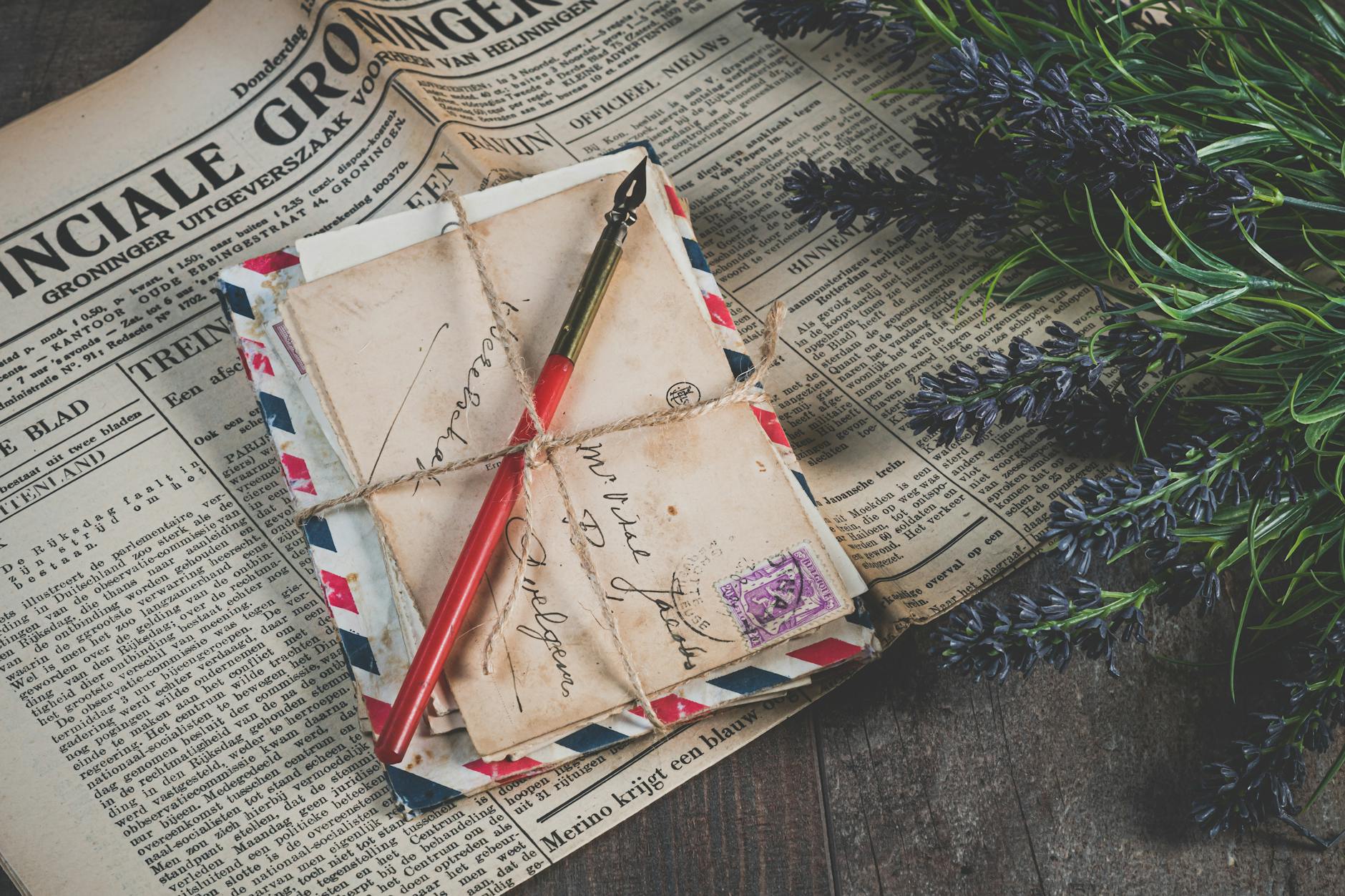 shallow focus photo of mail envelope on newspaper