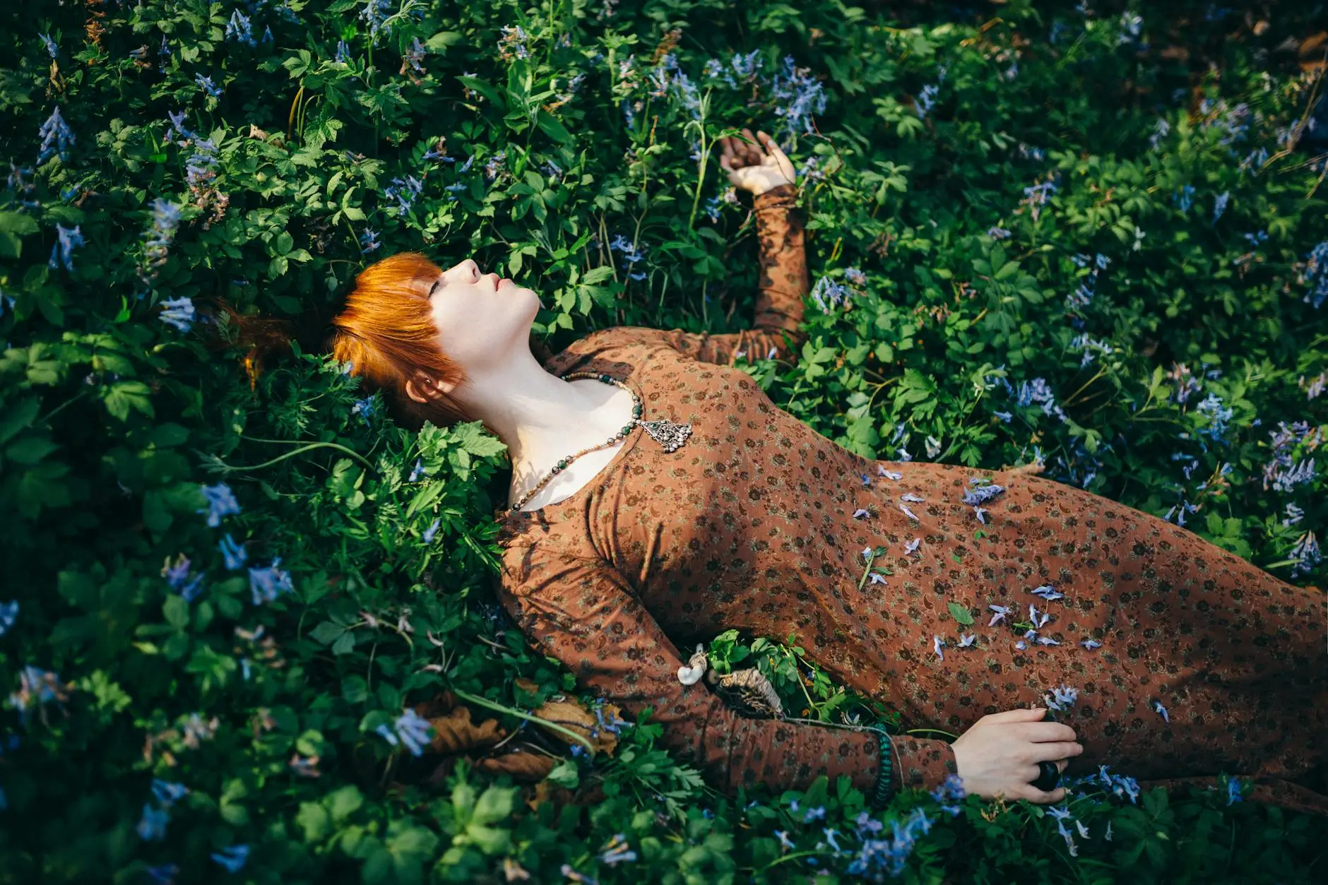 woman lying on flowering plants beltane how to celebrate beltane wheel of the year pagan holidays